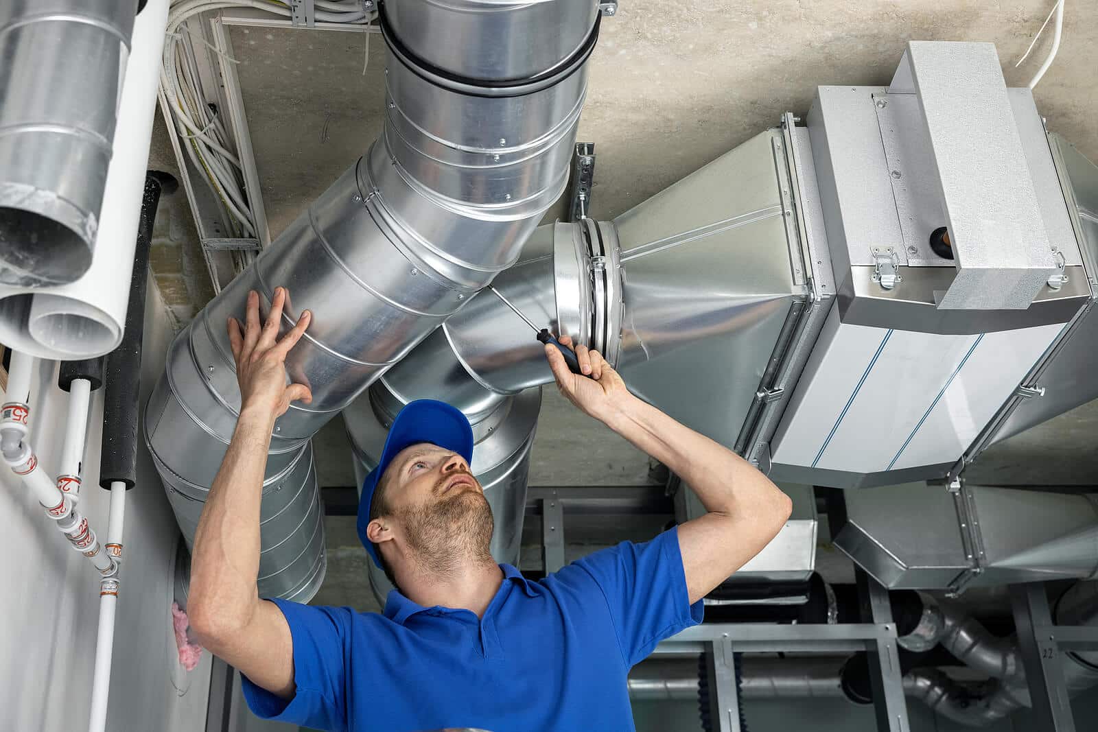 HVAC technician inspecting and repairing air ducts in El Dorado Hills