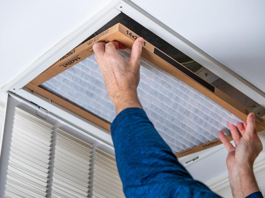 HVAC technician replacing a home air filter in El Dorado Hills