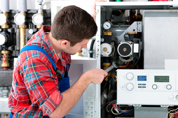 Heating technician repairing boiler controls in El Dorado Hills