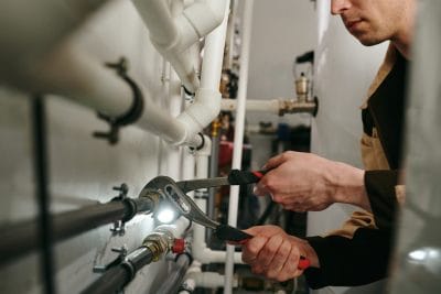 Technician inspecting commercial plumbing pipes in El Dorado Hills