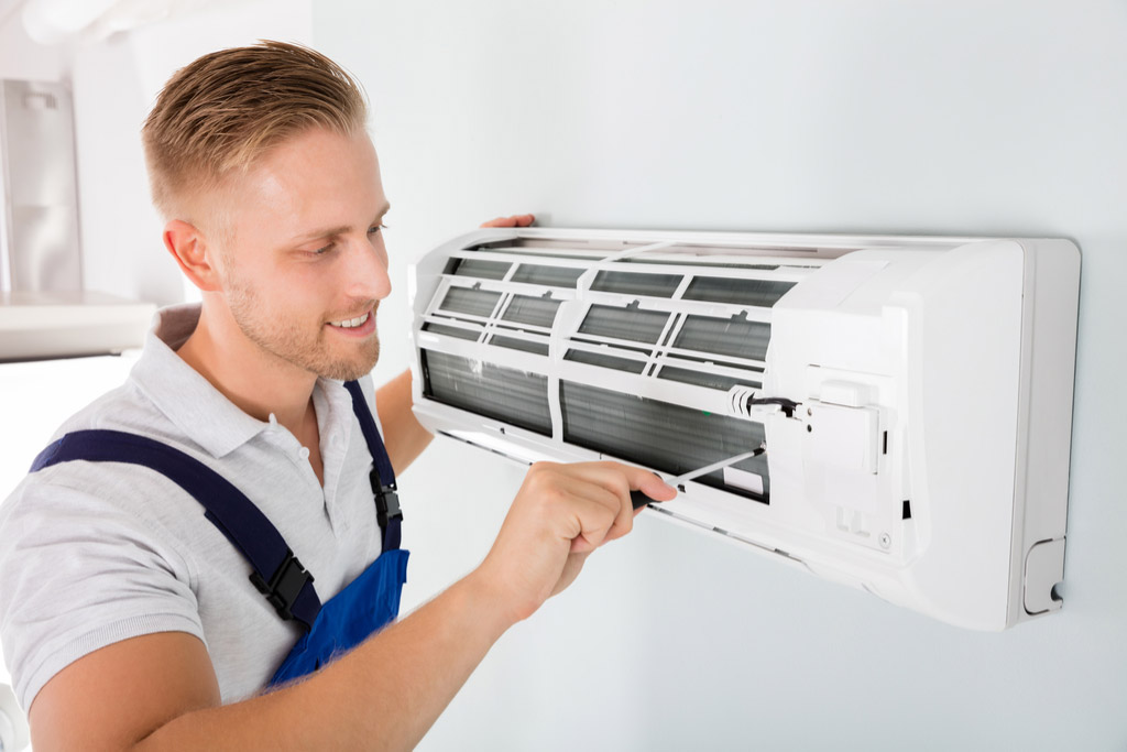 HVAC technician maintaining a ductless air conditioner in El Dorado Hills