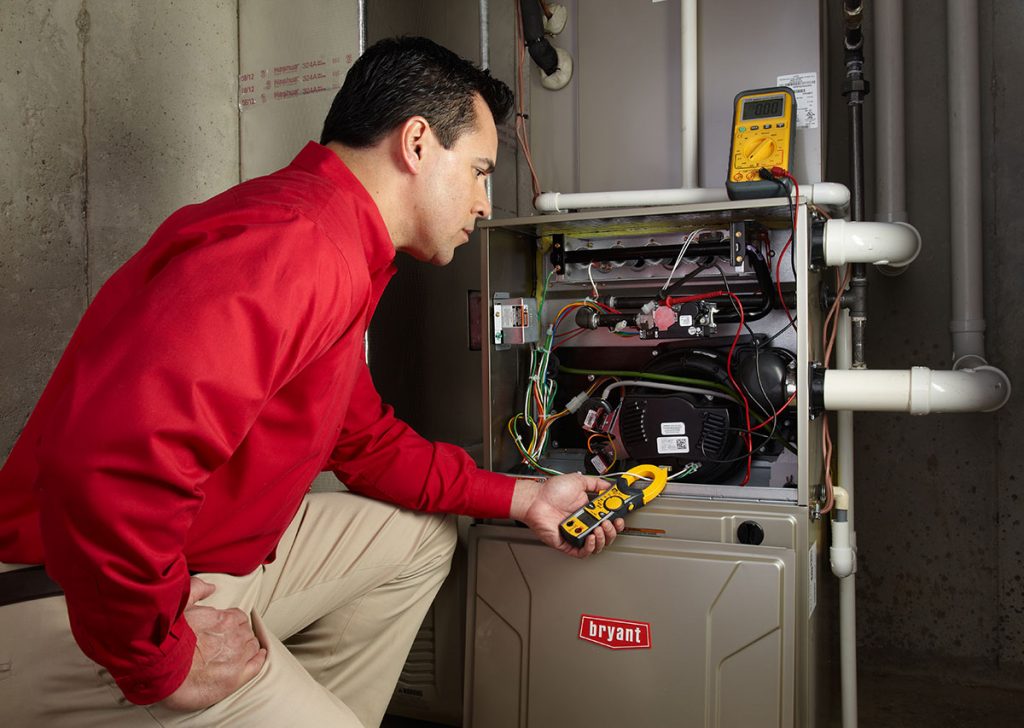 Heating technician diagnosing a furnace repair in El Dorado Hills