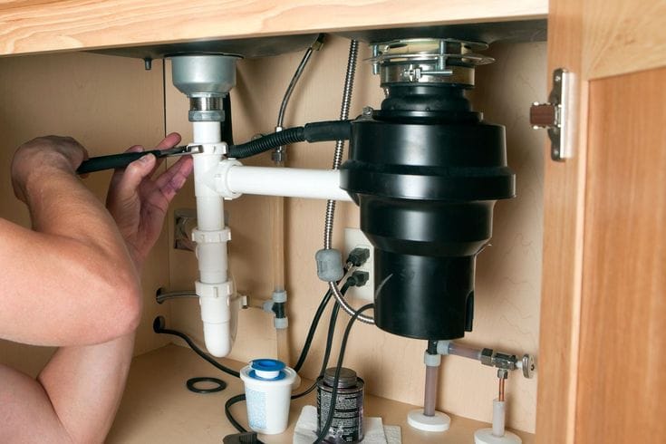 Plumber repairing a garbage disposal in El Dorado Hills