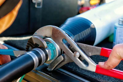 Technician repairing an industrial pipe connection in El Dorado Hills