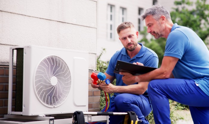 HVAC technicians installing an outdoor air conditioning unit in El Dorado Hills