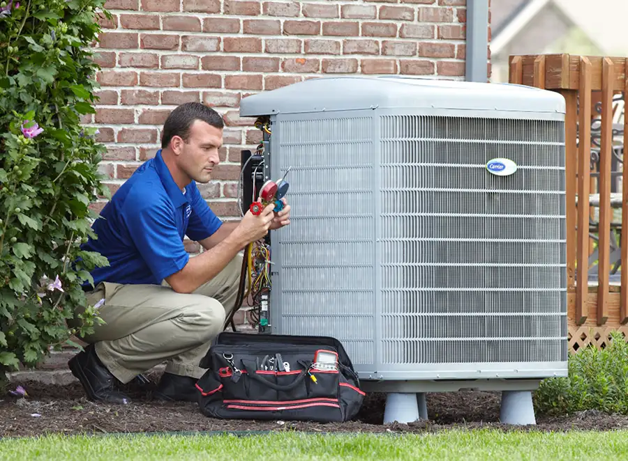 HVAC technician inspecting an outdoor AC unit in El Dorado Hills