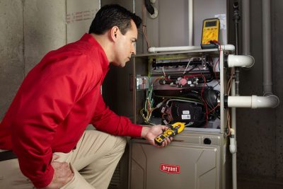 Heating technician diagnosing a furnace repair in El Dorado Hills