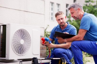 HVAC technicians installing an outdoor air conditioning unit in El Dorado Hills