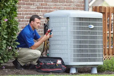 HVAC technician inspecting an outdoor AC unit in El Dorado Hills